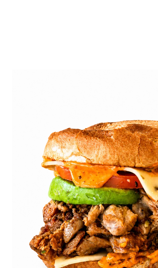 Hand holding a stacked bacon, egg and avocado sandwich